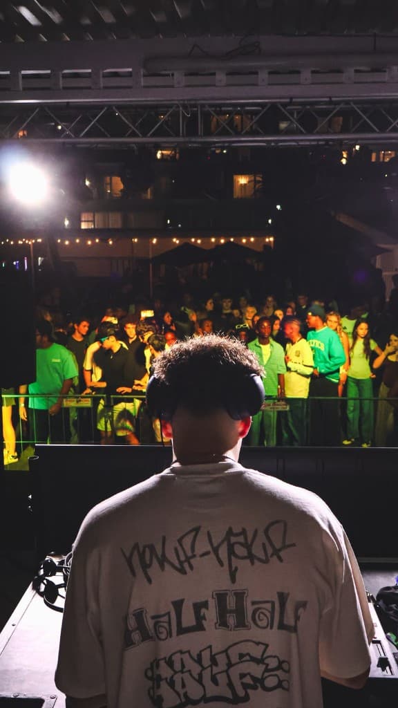 DJ facing the BALLITO-BIZA crowd from the stage